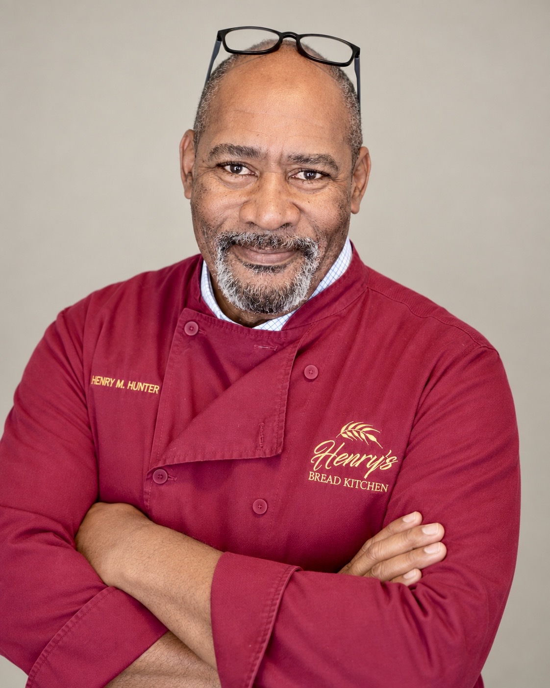 Henry Hunter in his burgundy chef’s jacket, arms crossed